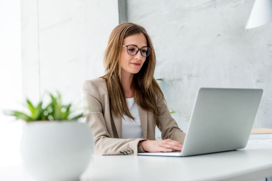 Beautiful Businesswoman typing on laptop